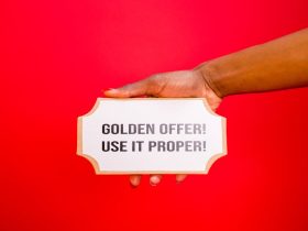 A Hand Holding a Signage