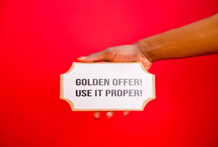 A Hand Holding a Signage