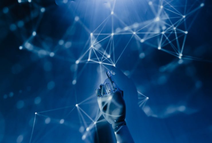 A robotic hand reaching into a digital network on a blue background, symbolizing AI technology.