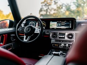 Interior of a luxury car highlighting a modern dashboard and steering wheel.