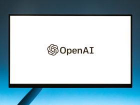 Minimalistic display of OpenAI logo on a monitor with a gradient blue background, representing modern technology.