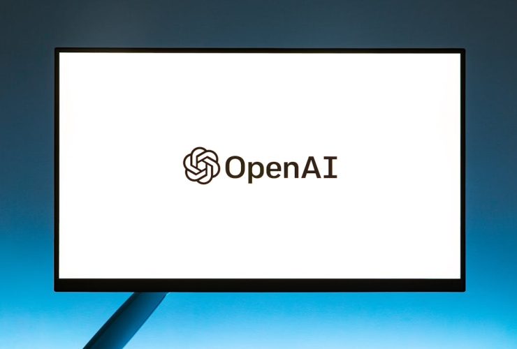Minimalistic display of OpenAI logo on a monitor with a gradient blue background, representing modern technology.