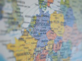 Close-up view of Germany on a colorful world map showing major cities.