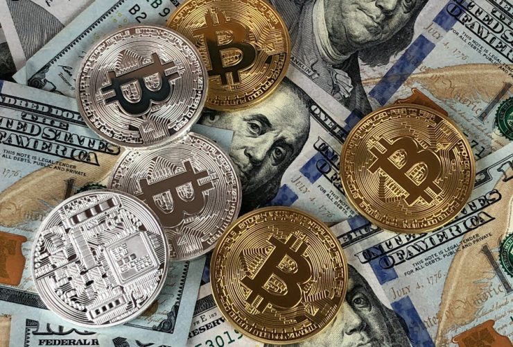 Close-up of bitcoins and US dollar bills symbolizing modern finance and cryptocurrency.