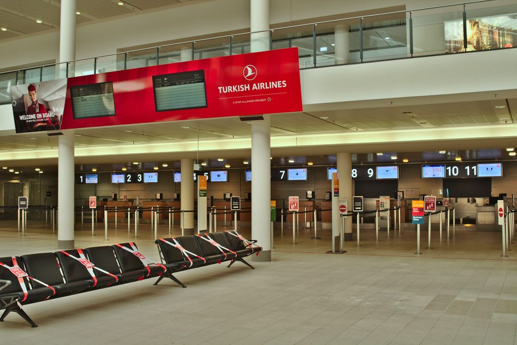 Departure hall of terminal 1 of Bremen Airport, deserted and with unmanned check-in counters during the Covid-19 crisis. Only