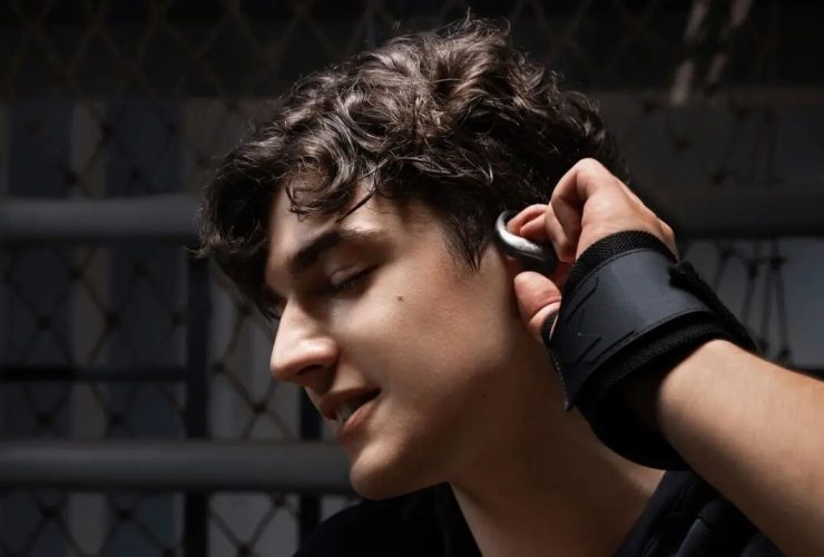 Persona che indossa gli auricolari open-ear Shokz OpenFit Air 2